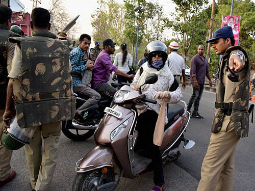 Security personnel check the identity of Students at Hyderabad Central University in Hyderabad on Wednesday. PTI Photo