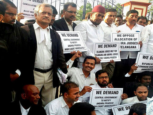 Telangana advocates holding placards at a protest in front of the High Court demanding separate High Court for Telangana, in Hyderabad on Monday. PTI Photo