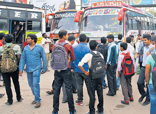 Commuters wait for private buses at Kempegowda bus stand.  dh photo