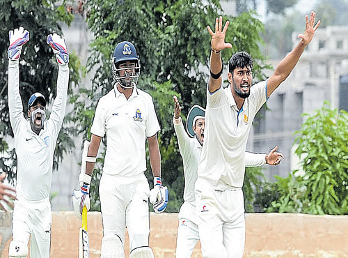 RUTHLESS: KSCAXI bowler Ronit More successfully appeals for the wicket of Bengal batsman Pragyan Ojha on Tuesday. DH PHOTO