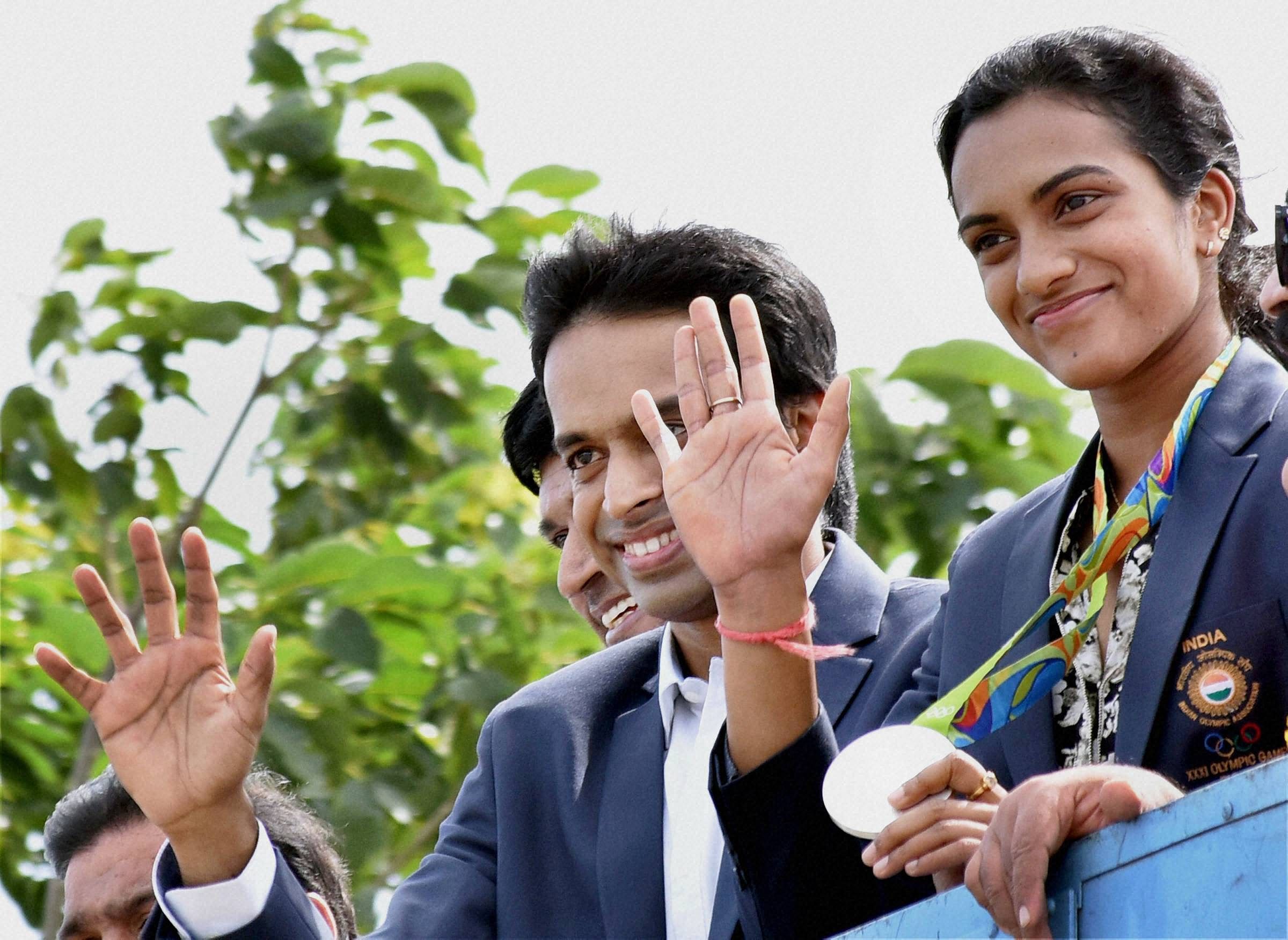 Telangana government today accorded a rousing reception and felicitated Sindhu and Gopichand at Gachibowli Stadium after their arrival from Rio. PTI photo