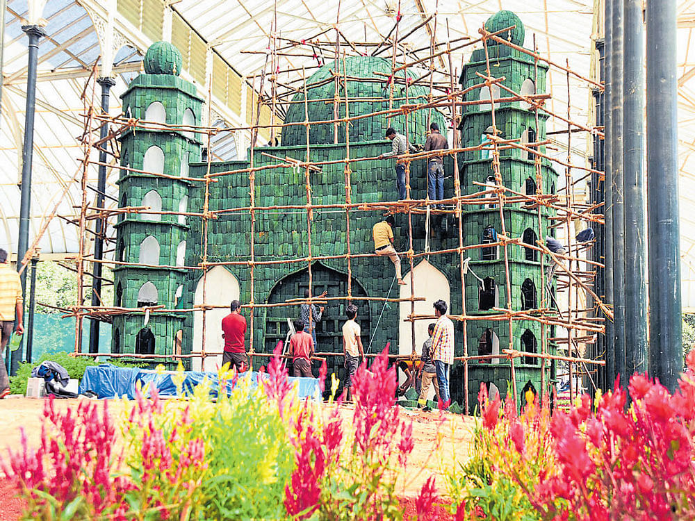 arrangements in place: (Clockwise from above) Work on a model of Vijayapura's Gol Gumbaz made of roses is in full swing ahead of the Republic Day Flower Show at the Glass House in Lalbagh Botanical Garden. Visitors buy medicine from Self-Aid vending machine located in front of the Glass House. DH PHOTO SATISH BADIGER