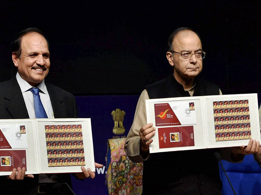 Finance Minister Arun Jaitley withthe Secretary of Post AP Singh releasing commemorative stamp during the launch of pilot branches of India Post Payments in New Delhi on Monday. PTI Photo