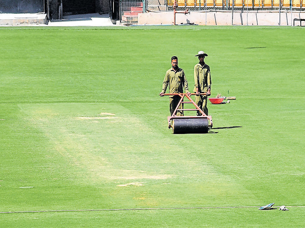 gearing up Ground staff at work at the Chinnaswamy Stadium ahead of the second Test against Australia, starting on Saturday. DH photo