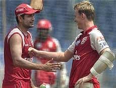 Kings XI Punjab's Irfan Pathan and Brett Lee during a practice session ahead of their next IPL match, in Mumbai on Monday. PTI