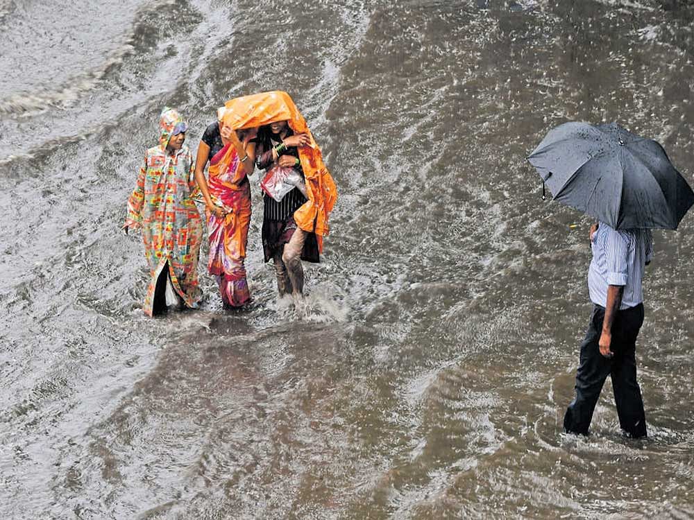 Impassable: Motorists make their way on a waterlogged street during heavy rain in Mumbai on Wednesday. AFP