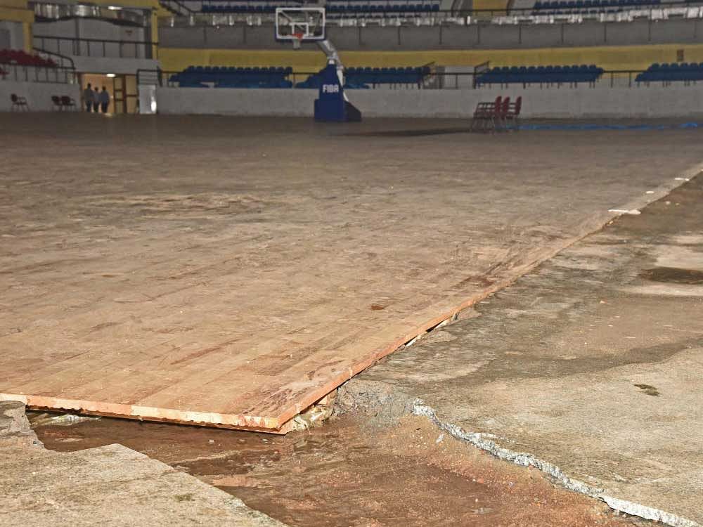 The maple wood playing surface at the Sree Kanteerava indoor stadium suffered damages following Monday's heavy rain. DH Photo