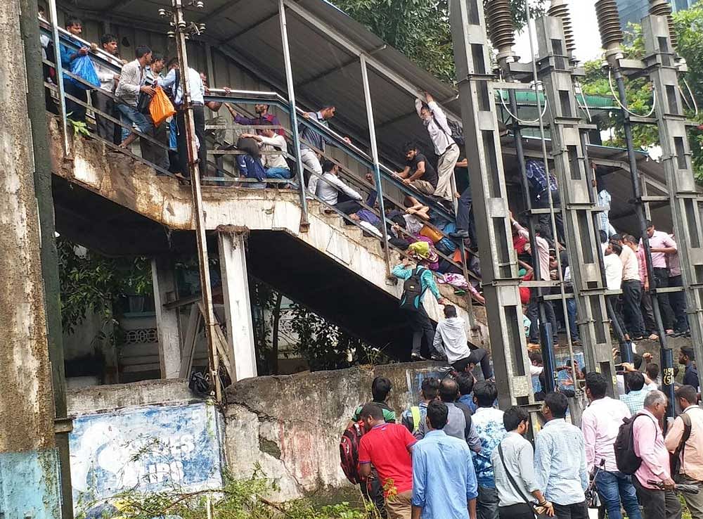 According to the report, the stampede was caused by heavy rains which forced people outside at the ticket counters to rush to the already jammed staircase for cover. DH file photo