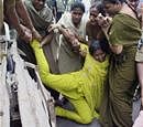 Police women arrest one of the girl students from Osmania University, belonging to Telangana region, protesting against Andhra Pradesh Public Service Commission's Group 1 exam, in Hyderabad on Sunday. PTI