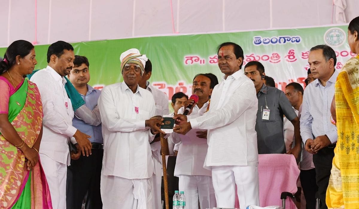 Telangana Chief Minister K Chandrasekhar Rao hands over the first 'Rythu Bandhu' cheque to a farmer, Sanjeeva Reddy, on Thursday.