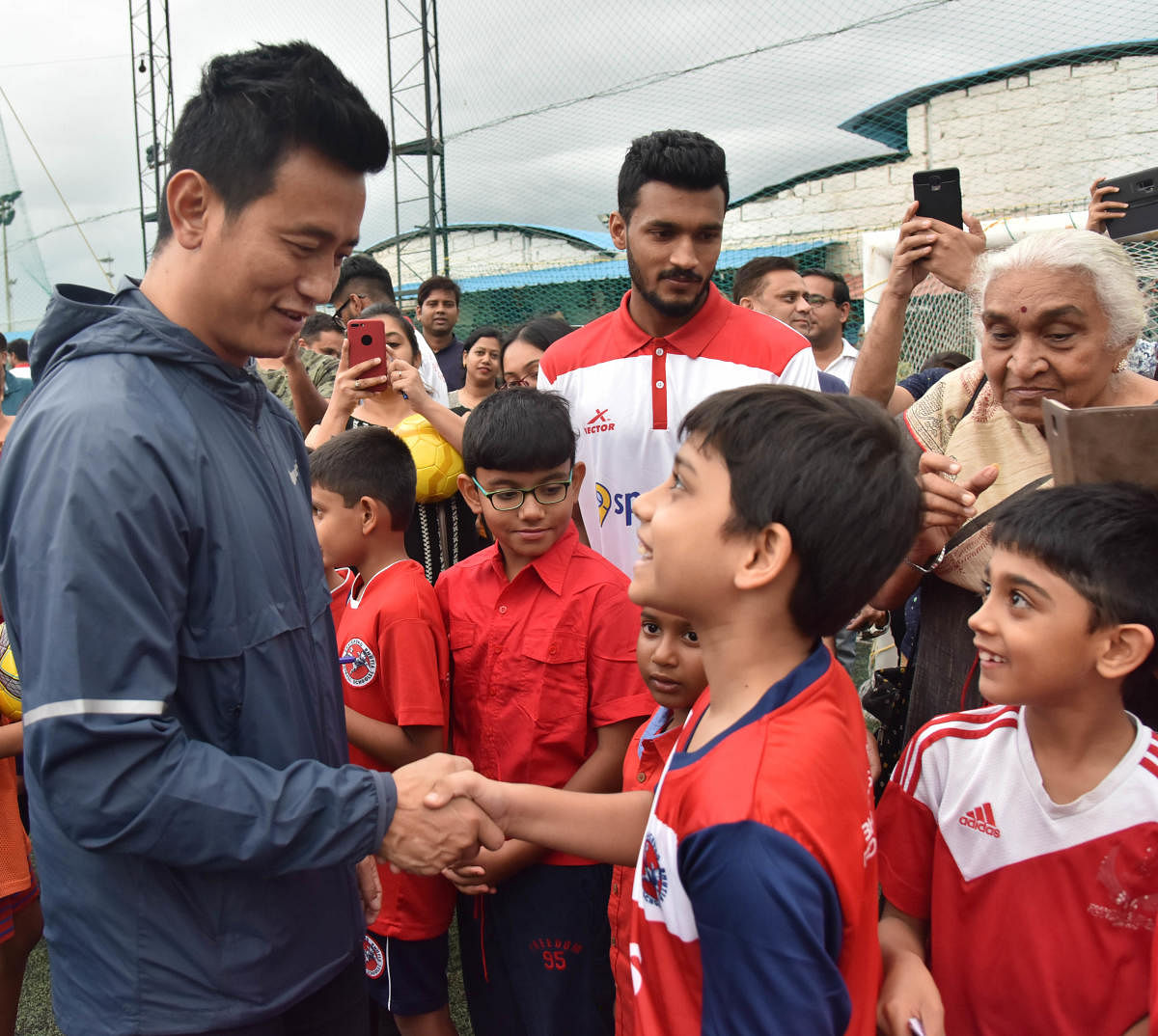 INSPIRATION Bhaichung Bhutia with aspiring young players during a promotional event on Sunday. DH PHOTO/ BK JANARDHAN