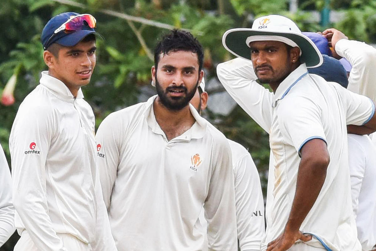 M G Naveen (centre) and Kushal Wawani (left) of KSCA Secretary's XI celebrate after dismissing an RSPB batsman at RSI ground in Bengaluru on Thursday. DH Photo