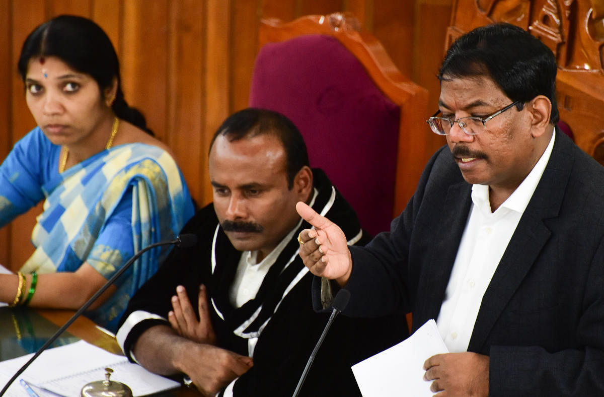 MP commissioner Manjunath Prasad speaks during the BBMP council meeting on Monday. Mayor Sampath Raj and his deputy Padmavathi Narasimhamurthy are also seen. dh photo