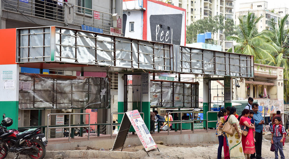 The display board, which was removed during the elections in May, remains bare to this day at a bus stop in the city. DH Photo/B H Shivakumar