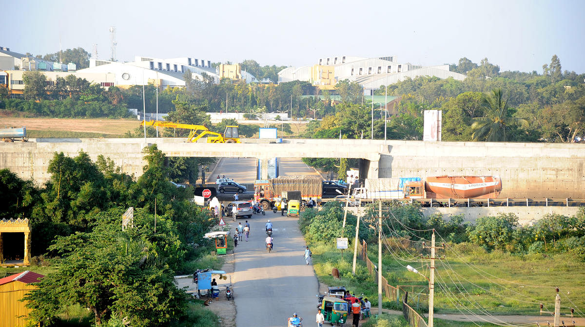 The flyover providing two underpass entries to Bengaluru International Exhibition Center under construction on Tumkur road in Bengaluru on Wednesday. DH Photo/Srikanta Sharma R.