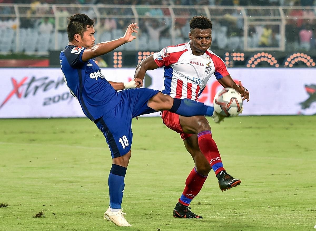 KEEN TUSSLE: ATK player Kalu Uche (9) vies for the ball with Jerry Lalrinzuala (18) of Chennaiyin FC. PTI