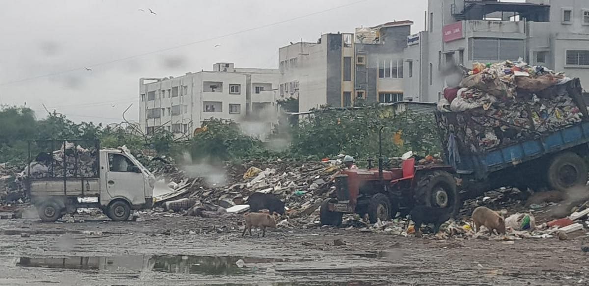 BBMP staff dumping garbage at a vacant plot in Ranka Colony, off Bannerghatta Road.