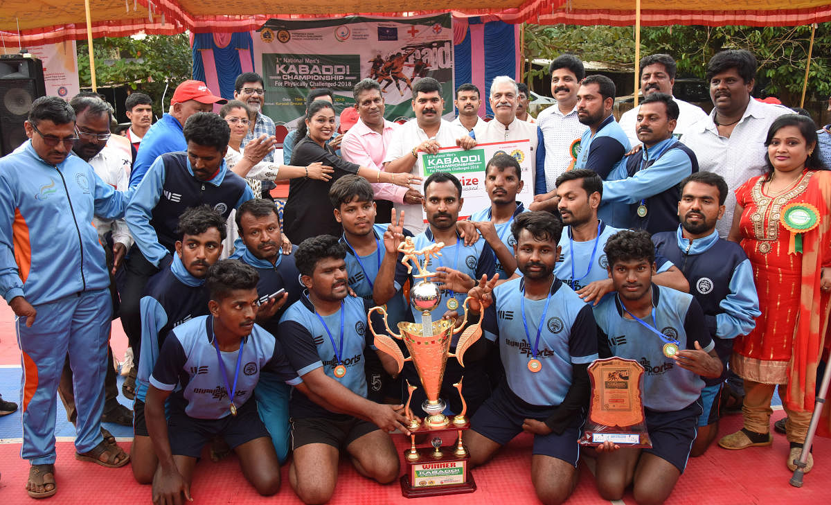 Karnataka team members pose for a photograph with the championship trophy after emerging victorious at the national-level Kabaddi tournament for physically challenged persons. DH Photo