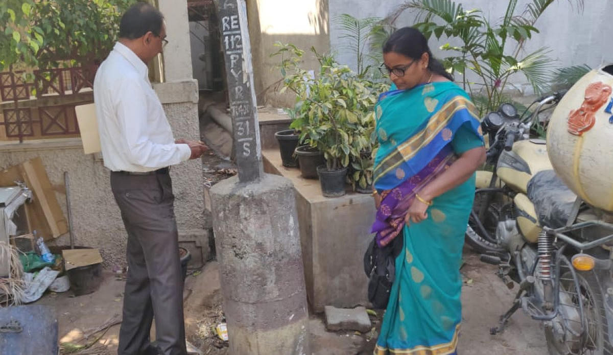 BBMP officials inspect two restaurants that have violated SWM rules and connected sewage lines to the BWSSB main drain at Domlur on Monday.