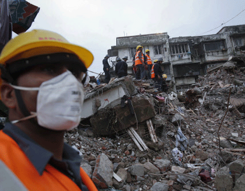 Rescue workers search through rubble at the site of a collapsed residential building in Mumbai reuters Image