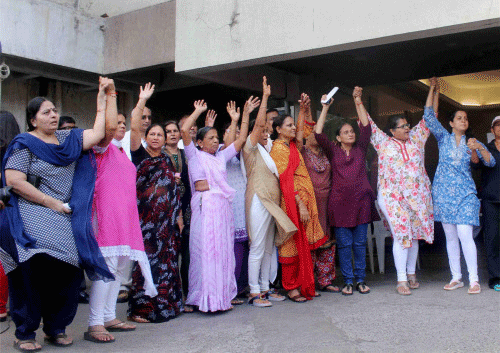 Mumbai municipal officials today descended on the posh Campa Cola society to cut off essential supplies to the illegal flats but are facing stiff resistance from the residents, who have blocked their entry by locking up the gates and forming human barricades. PTI photo