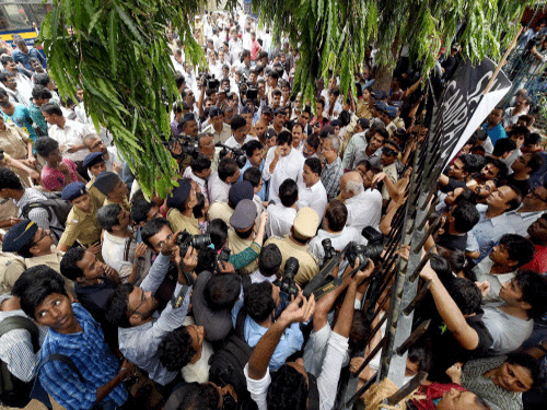 Campa Cola residents block the entrance for the BMC officials who arrived to disconnect the water and electricity supply of the society. PTI photo