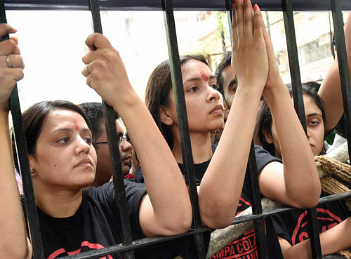 we won't go: Campa Cola residents block the entrance for the BMC officials who arrived to disconnect water and  electricity supply to the society in Mumbai on Friday. pti