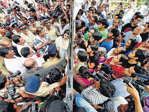 Campa Cola residents block the entrance for the BMC officials who arrived to disconnect the water and electricity supply of the society, in Mumbai on Saturday. PTI photo