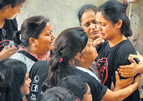 Residents of the Campa Cola society weep after BMC Deputy Commissioner, Anand Waghlarkar warned them of serious repercussions if they continue to create roadblocks in BMC's work in Mumbai on Sunday. PTI photo