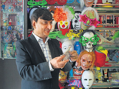 Chandresh Panchmatia performs a trick in his shop in Mumbai