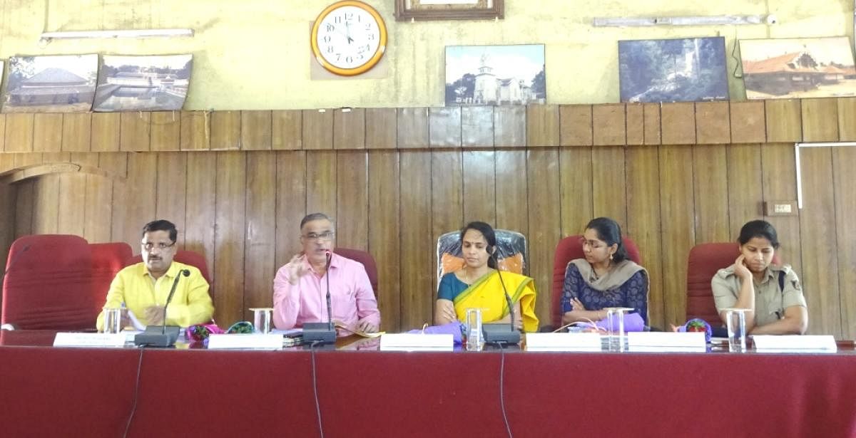 State Commissioner for Persons with Disabilities V S Basavaraju (2nd from left) addresses a meeting at Old Fort Hall in Madikeri.