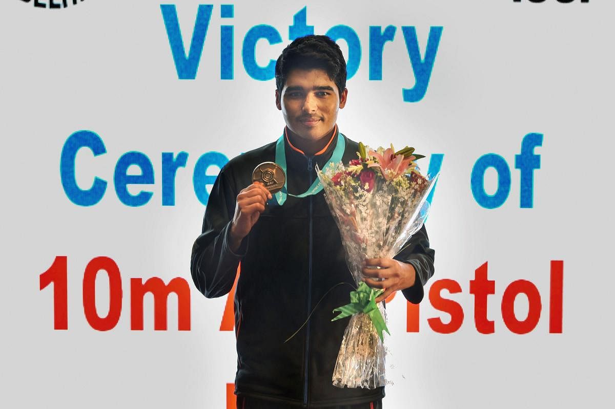 SHINING BRIGHT: India's Saurabh Chaudhary with his gold medal at the ISSF World Cup in New Delhi. PTI