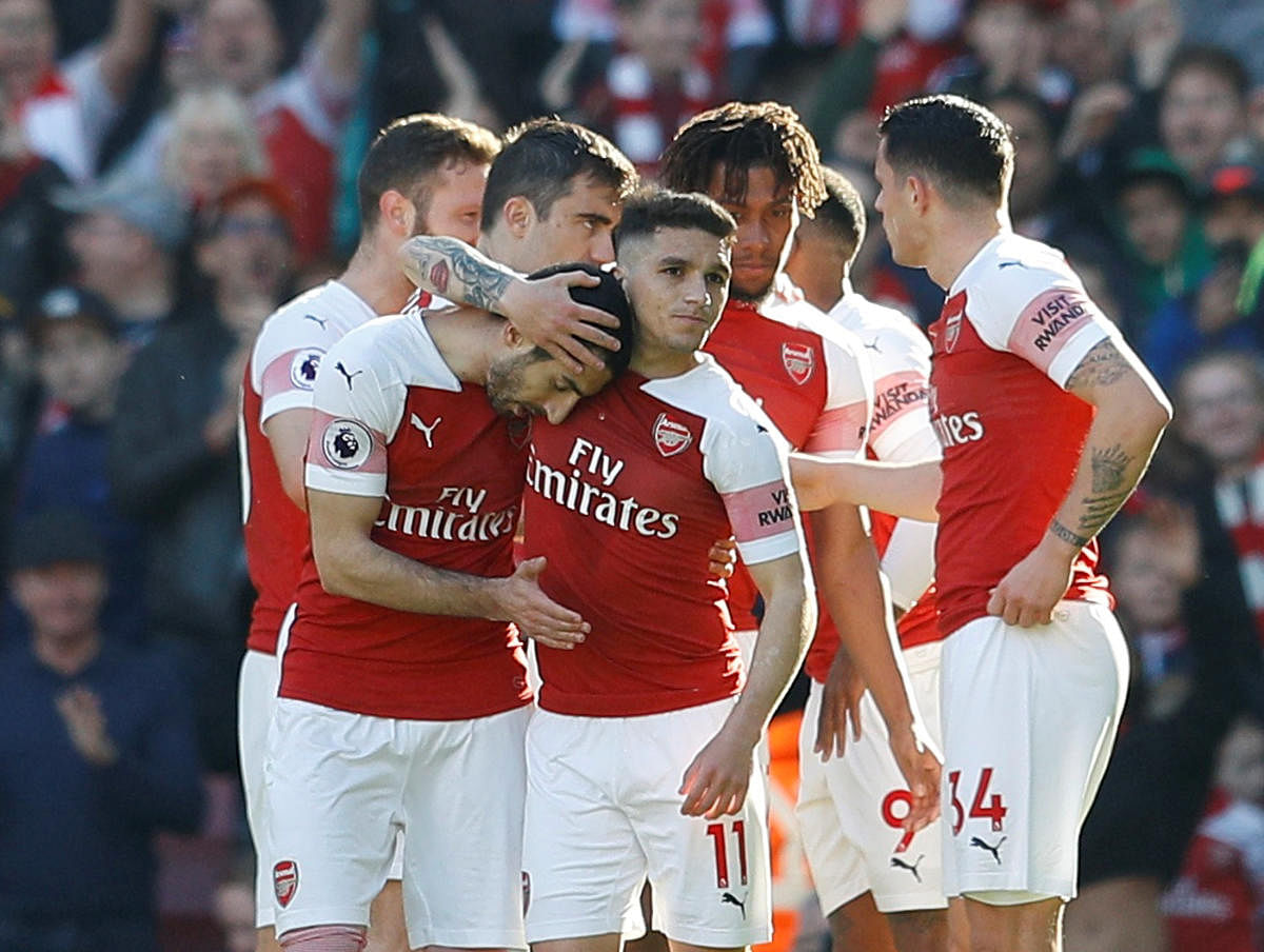 EASILY DONE: Arsenal's Henrikh Mkhitaryan (left) celebrates with team-mates after scoring their second goal against Southampton on Sunday. 