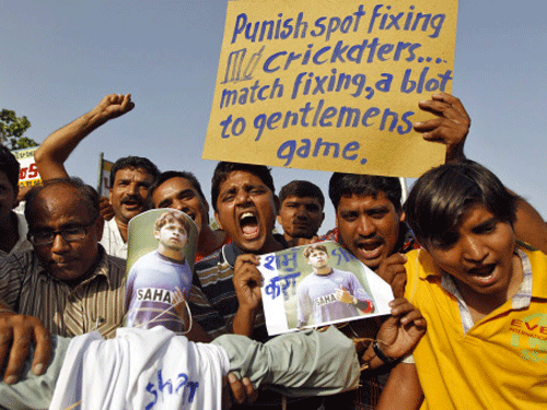 File image: File photo of demonstrators shouting slogans as they hold a placard and posters of former India test bowler Shanthakumaran Sreesanth during a protest in Ahmedabad. Reuters