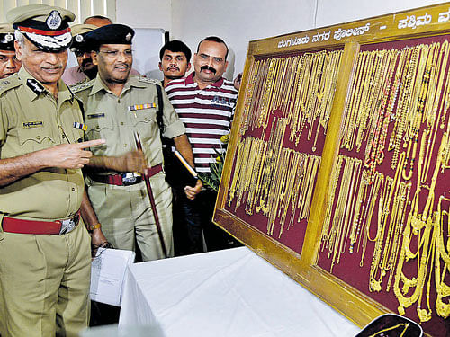 City Police Commissioner N S Magharikh with the gold  ornaments that were stolen from Manappuram Finance Ltd in the City, on Monday. KPN