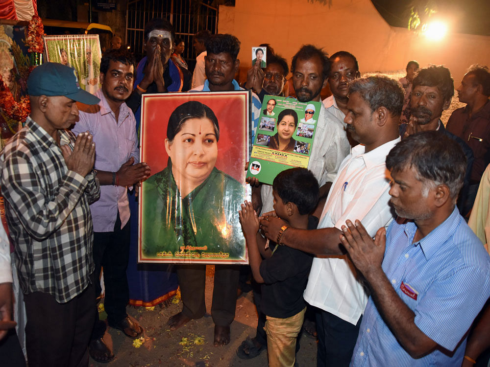 Fans and supporters and others perform prayers by holding portrait of Tamil Nadu Chief Minister J Jayalaithaa for health, at Sunrise Arunachalam Circle, Srirampura in Bengaluru. DH Photo.