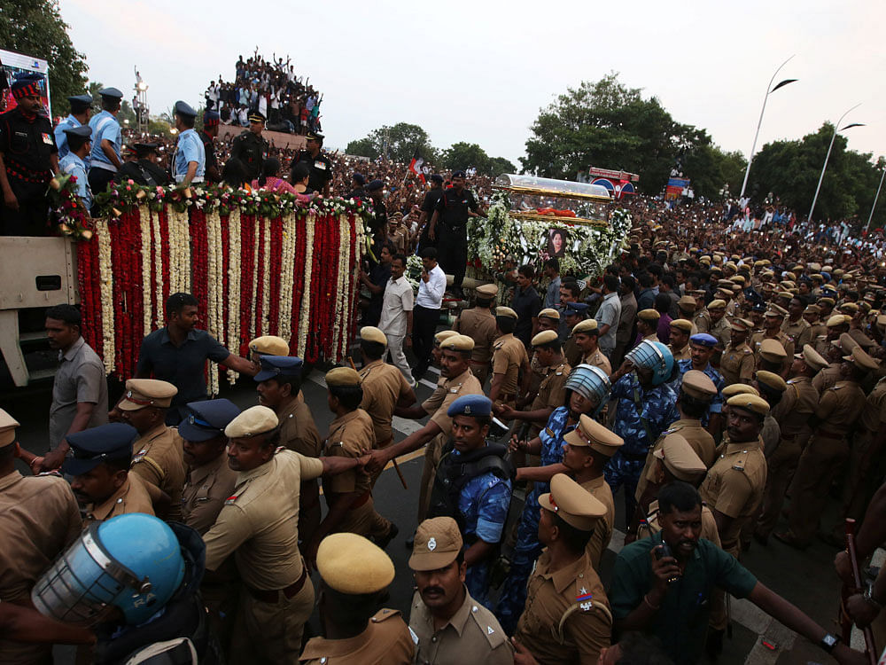 Supporters of Tamil Nadu Chief Minister Jayalalithaa Jayaraman crowd around the vehicle carrying her body during her funeral procession in Chennai. Reuters Photo.