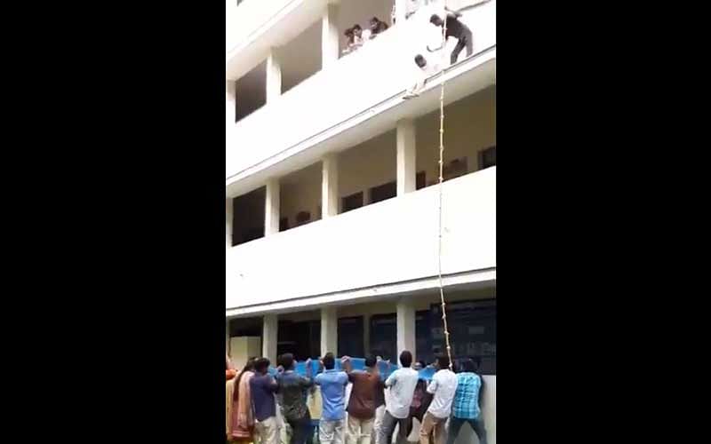 In a video clip of the incident, which had gone viral, N Logeshwari, a second-year BBA student, appears reluctant to take the jump even though a net was held by a group of students to ensure a safe landing. It showed the 31-year-old trainer pushing down Logeswari, who then hit a sunshade on the first floor. (Screengrab)