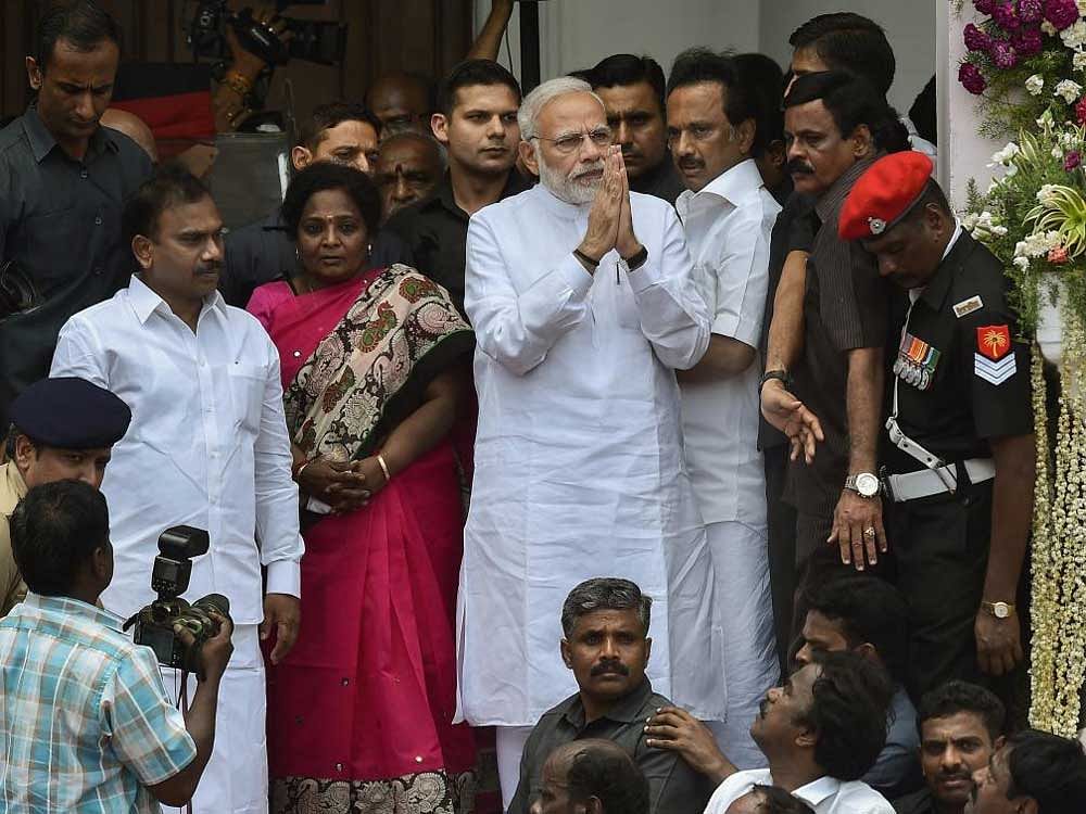 Prime Minister Narendra Modi expresses his condolence to DMK supporters and worker on the demise of their Party chief M Karunanidhi at Rajaji Hall, in Chennai on Wednesday. PTI Photo