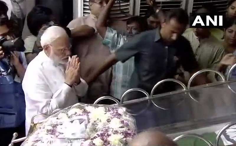 Clad in white, Modi laid a wreath at Karunanidhi's feet and bowed before his mortal remains, paying his respect to the late leader. (ANI Photo)