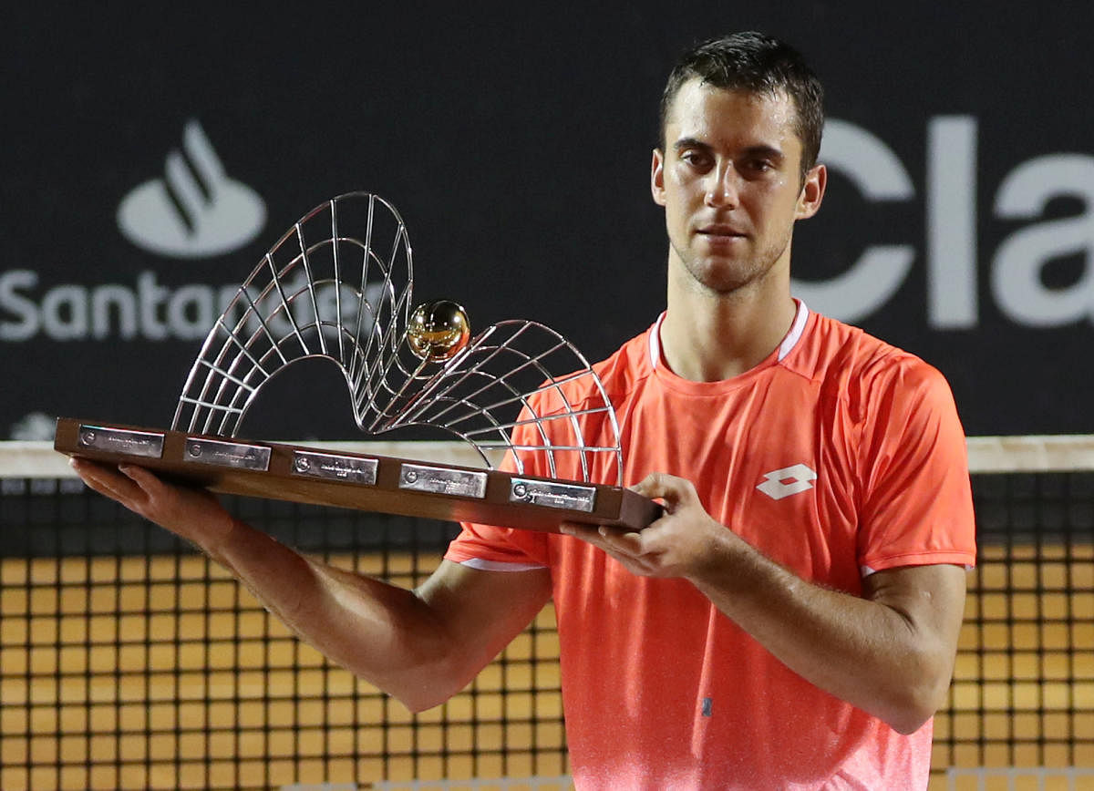 Serbia's Laslo Djere with the Rio Open trophy after defeating Felix Auger-Aliassime of Canada on Sunday. REUTERS