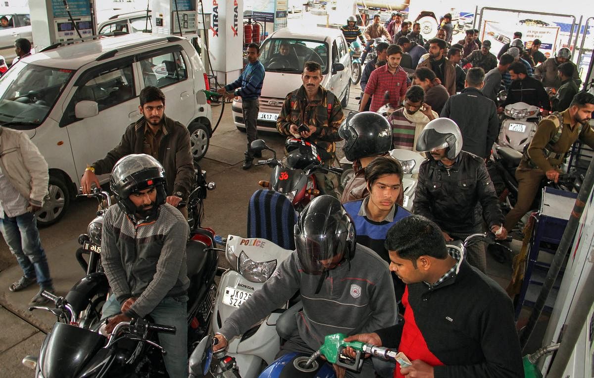 Commuters queue up at a petrol pump during a three-hour curfew relaxation for the first time since the imposition of curfew, in Jammu, on February 18, 2019. PTI