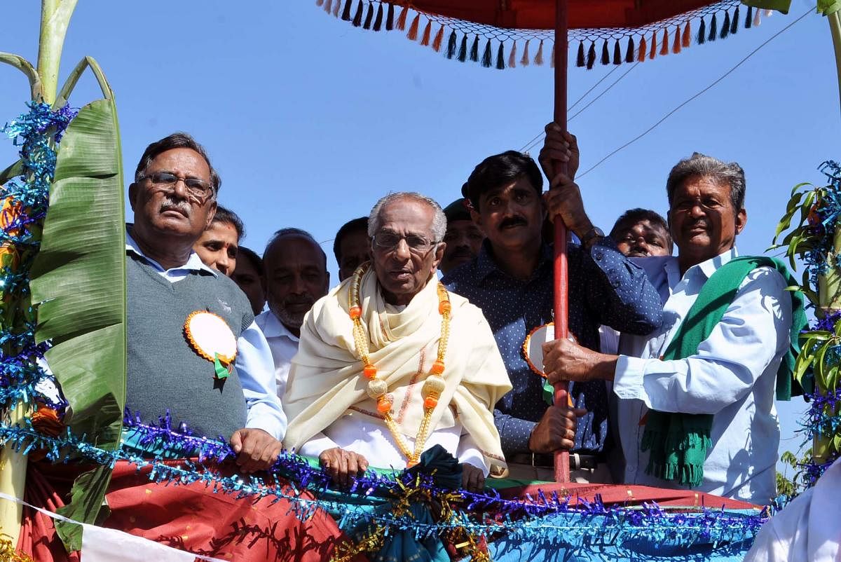 Writer Go Ru Channabasappa being taken to a folk convention in a procession at Chikkamagaluru on Sunday.