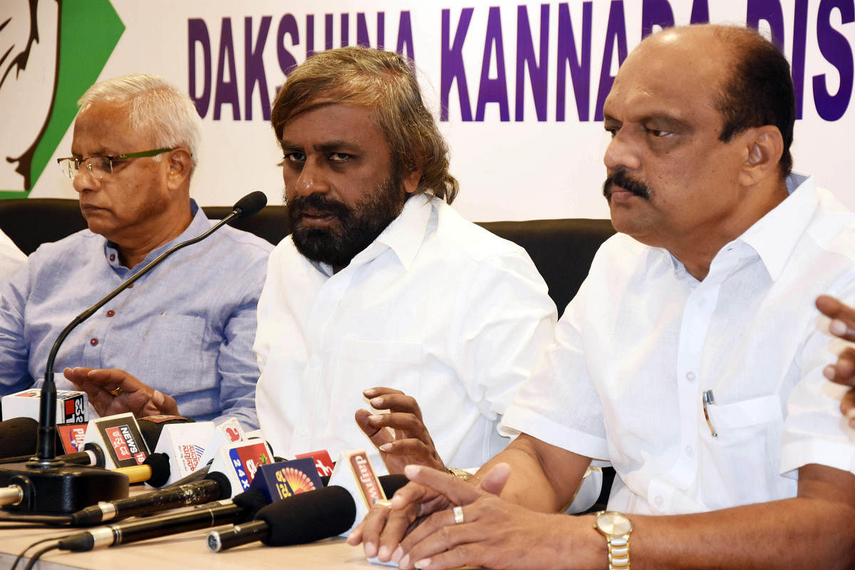KPCC working president Eshwar Khandre speaks during a press meet at the district Congress Committee office in Mangaluru on Monday. MLC and District Congress president Harish Kumar and former MLA J R Lobo look on.