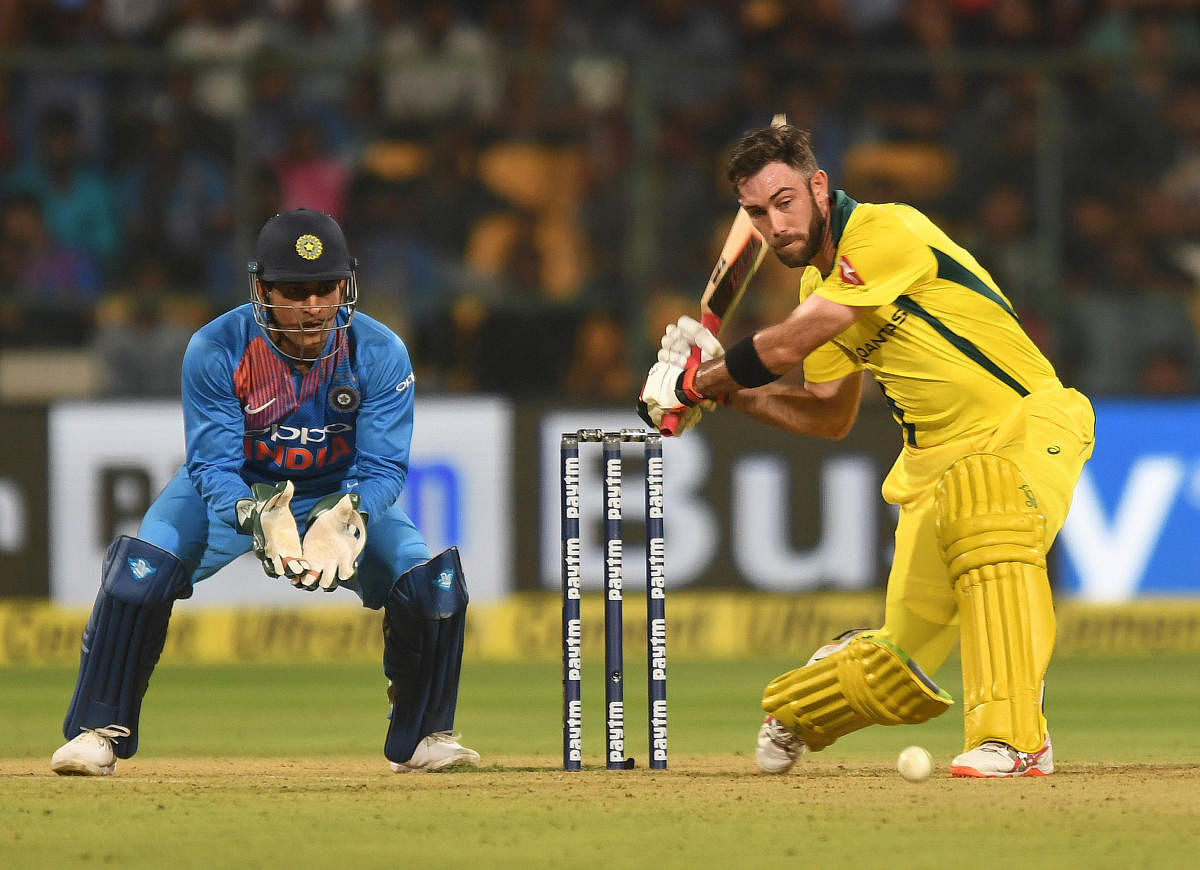 SINGING INNINGS: Australia's Glenn Maxwell coils up to send one over the fence en route his unbeaten 113 in the second T20I against India at the M Chinnaswamy Stadium in Bengaluru on Wednesday. DH Photo/ Srikanta Sharma R