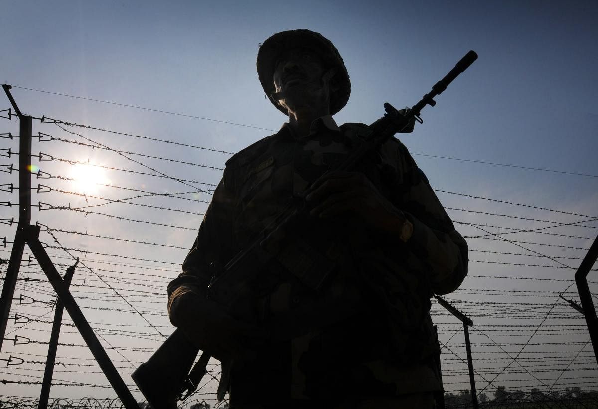 Border Security Force (BSF) personnel stand guard along the international border as security beefs up amid escalating tension between India and Pakistan, at Attari near Amritsar, Thursday. PTI photo
