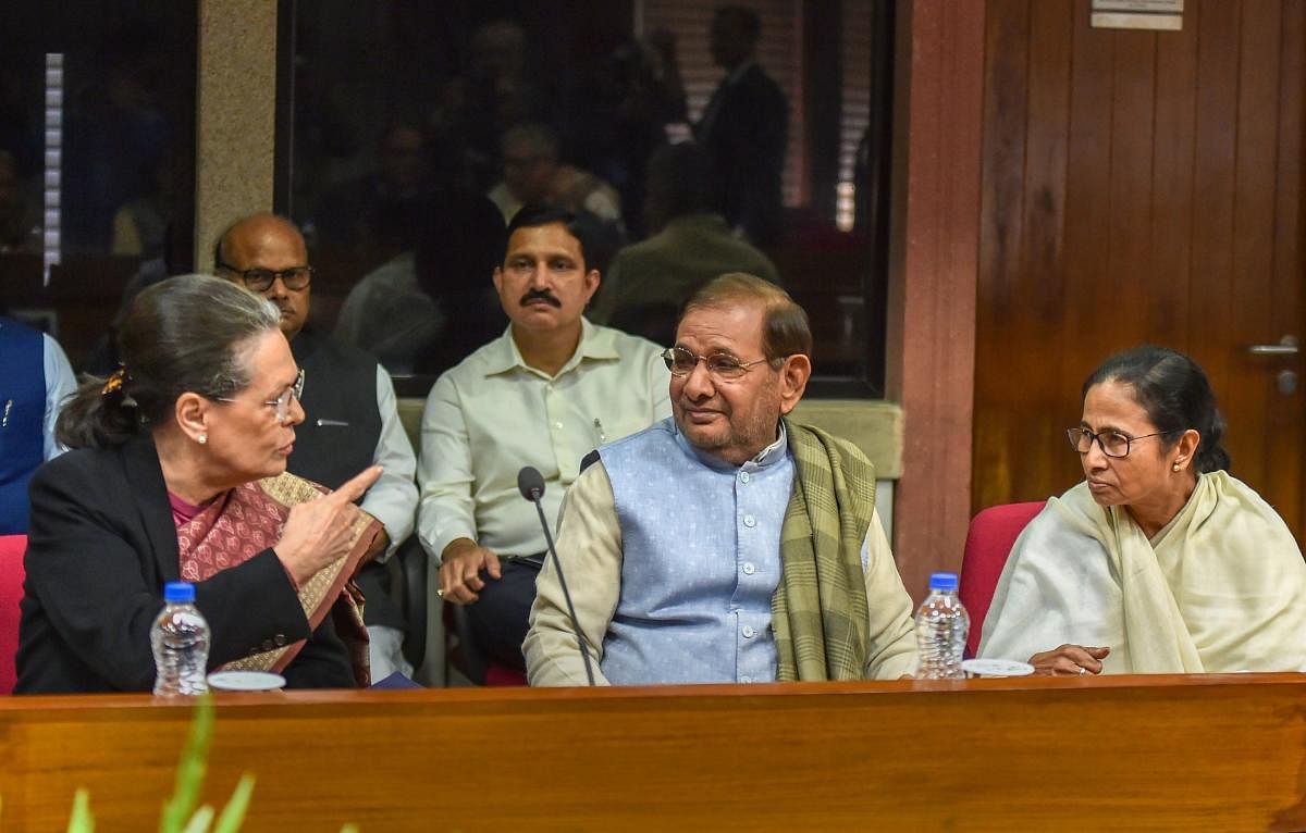Senior Congress leader Sonia Gandhi, Loktantrik Janta Dal leader Sharad Yadav and West Bengal Chief Minister Mamata during the Opposition parties' meet at Parliament House complex, in New Delhi on Wednesday. (PTI Photo)