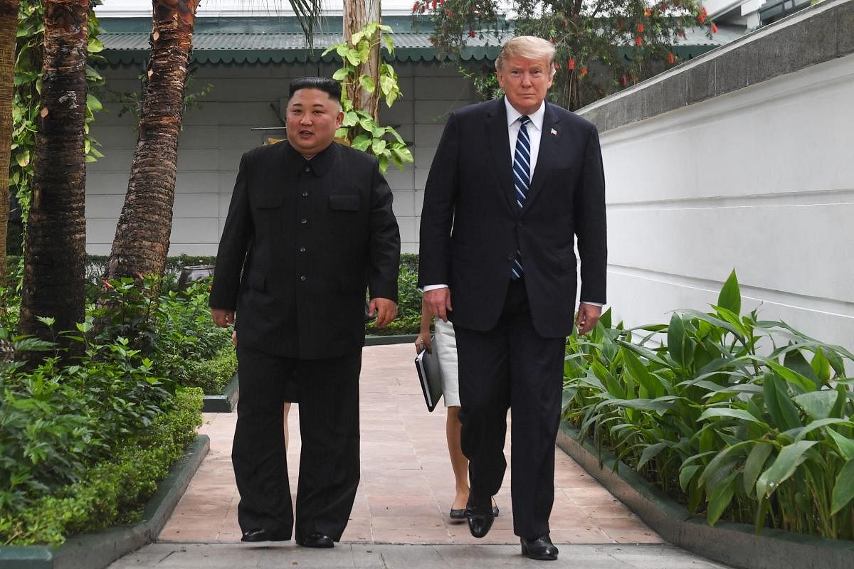 US President Donald Trump (R) walks with North Korea's leader Kim Jong Un during a break in talks at the second US-North Korea summit at the Sofitel Legend Metropole hotel in Hanoi on Thursday. (AFP)
