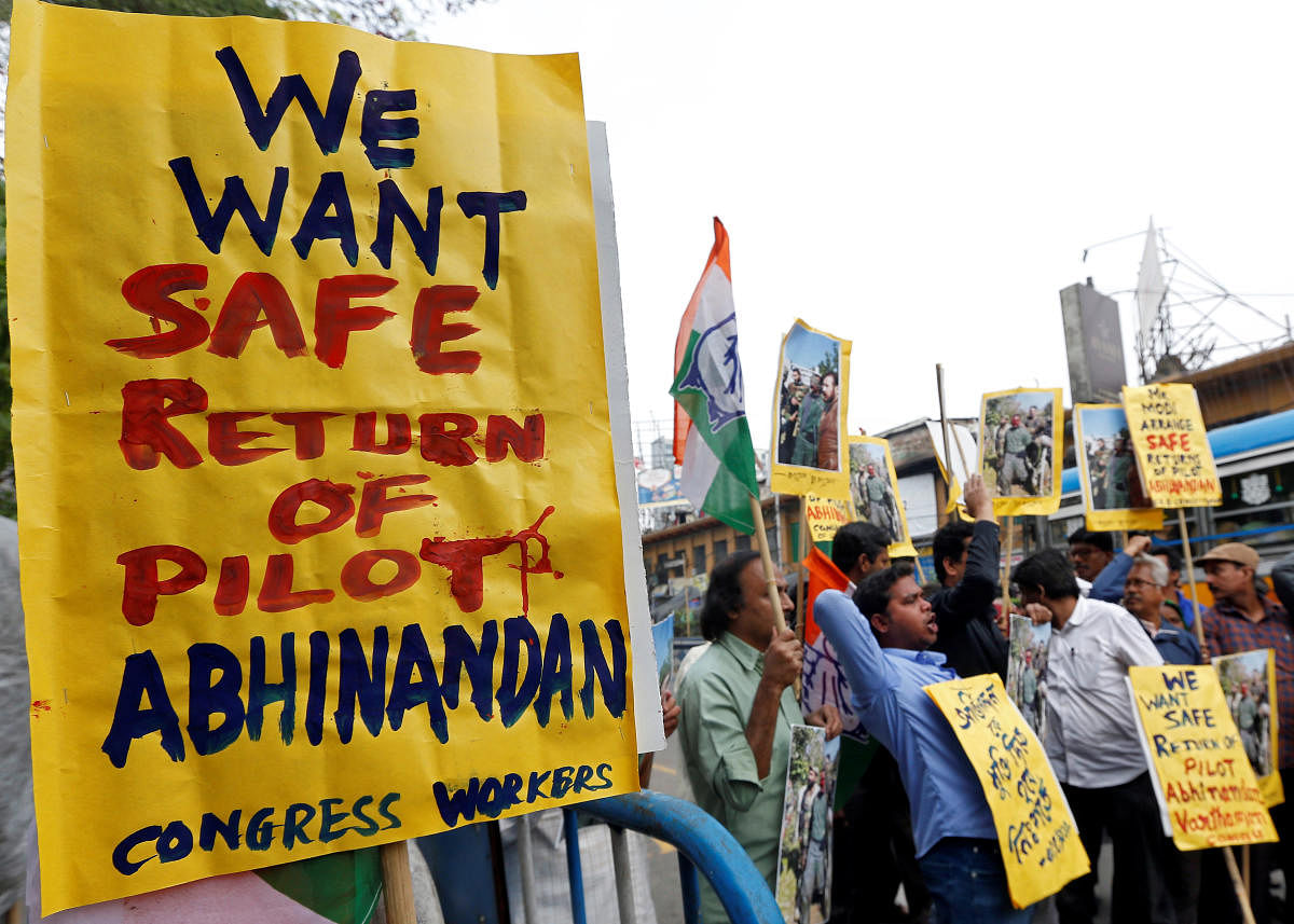 Demonstrators hold placards and shout slogans in Kolkata during a protest demanding the release of an Indian Air Force pilot after he was captured by Pakistan. (Reuters Photo)