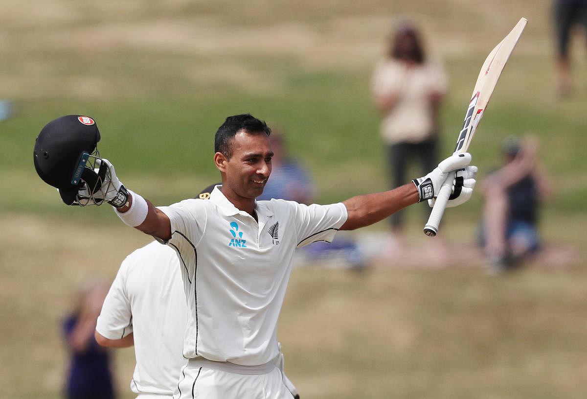 MAIDEN TON New Zealand's Jeet Raval celebrates his century on the second day of the first Test against Bangladesh in Hamilton on Friday. AFP